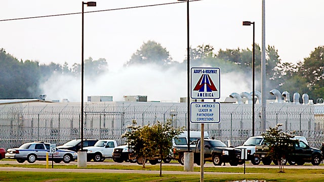 Smoke rises above the Adams County Correctional Center in Natchez, Miss., May 20, 2012, during an inmate disturbance at the prison. 