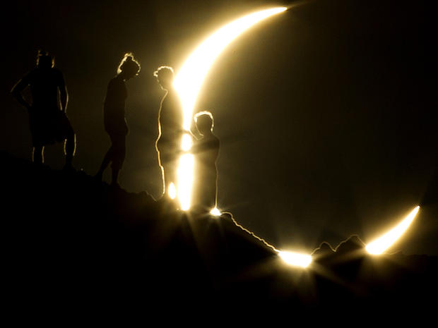 Hikers watch an annular eclipse from Papago Park in Phoenix May 20, 2012. 