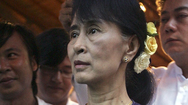 Myanmar opposition leader Aung San Suu Kyi looks at a photo during the opening ceremony of a photo exhibition entitled "Aung San Suu Kyi, The Burmese Way to Democracy" at Institute of French in Yangon, Myanmar, May 17, 2012. 