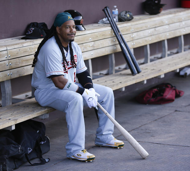 Manny Ramirez sits in the visiting team dugout before a Triple-A baseball game 