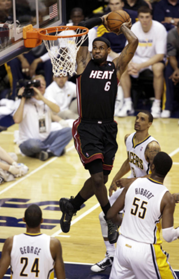LeBron James  dunks in front of George Hill  