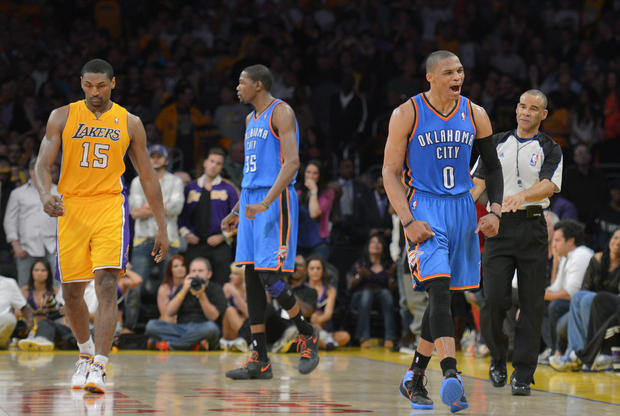 Russell Westbrook celebrates as Metta World Peace and forward Kevin Durant look on 