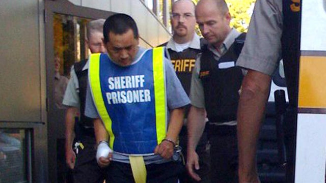Vince Weiguang Li, 40, is led into the Manitoba Provicial Court in Portage La Prairie, Manitoba, Aug. 1, 2008. 