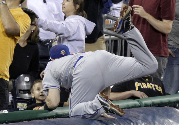 David Wright goes over the tarp after not being able to get to an eighth-inning foul ball  