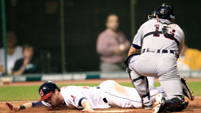 Jason Kipnis tags home plate to score as Alex Avila is late on the tag 