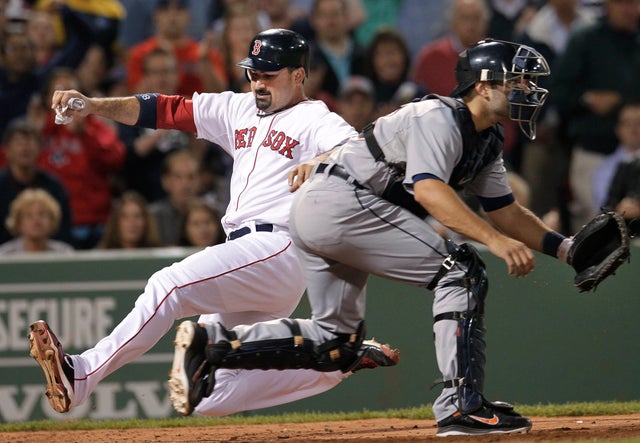 Adrian Gonzalez slides safely into home to score on a double 