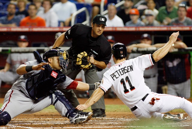 Bryan Petersen attempts to score but is tagged out by catcher Jhonatan Solano 