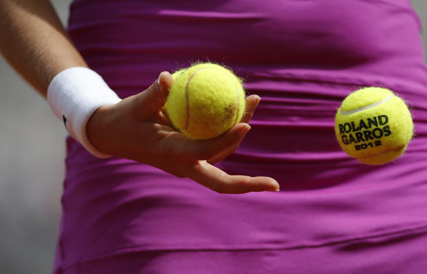 Petra Kvitova throws a ball back to a ball boy  