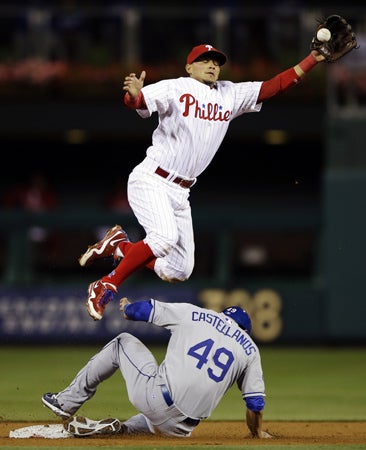 Freddy Galvis leaps for a high throw 