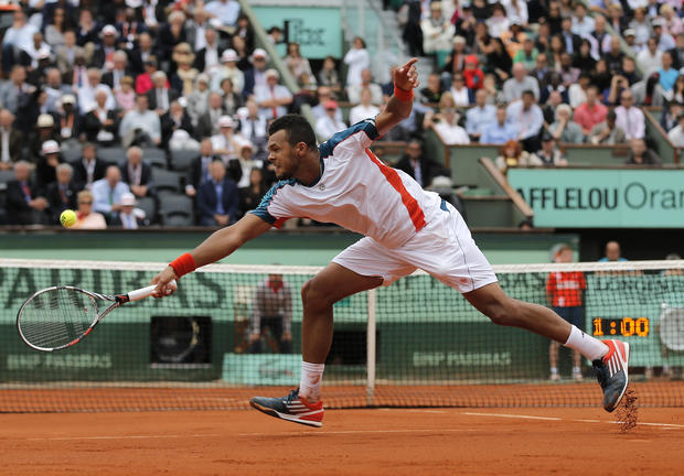 Jo-Wilfired Tsonga returns the ball to Novak Djokovic 
