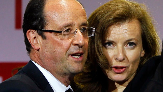 French president Francois Hollande reacting to supporters with his companion Valerie Trierweiler while celebrating his election victory in Paris on May 6, 2012. 