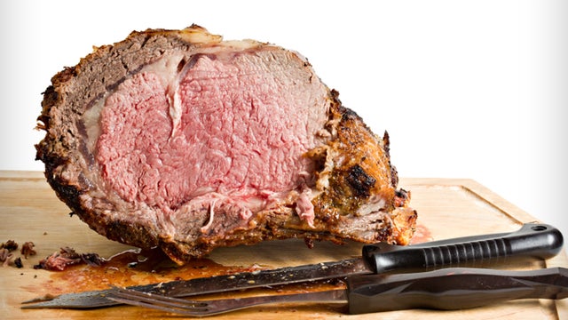 Sliced Roasted Prime Rib With Knife On Plank 