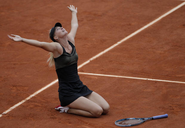 Maria Sharapova reacts as she defeats Italy's Sara Errani  