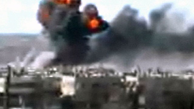 This video image taken from amateur video and broadcast by Bambuser/Homslive shows a series of devastating explosions rocking the central Syrian city of Homs, Syria, Monday, June 11, 2012. 