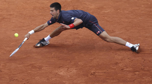 Novak Djokovic  returns in the mens final match against Rafael Nadal 