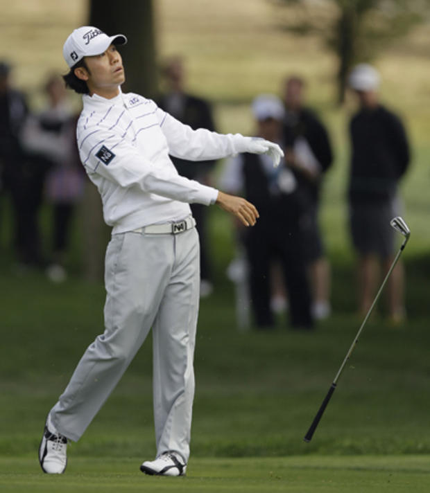 Kevin Na tosses his club after hitting on the 16th hole  