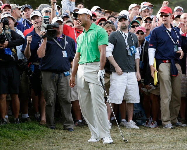 Tiger Woods reacts after a shot 