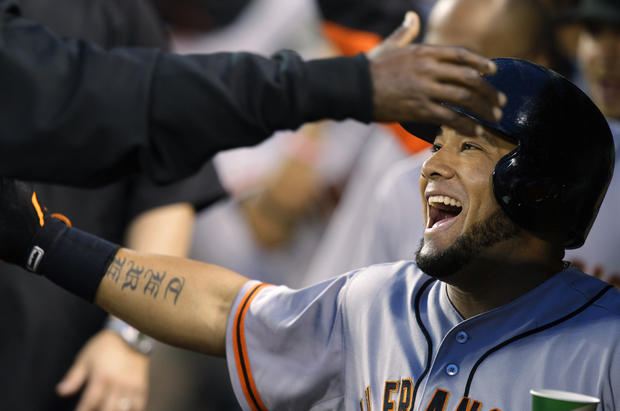 Melky Cabrera is greeted in the dugout after he hit a two-run home run 