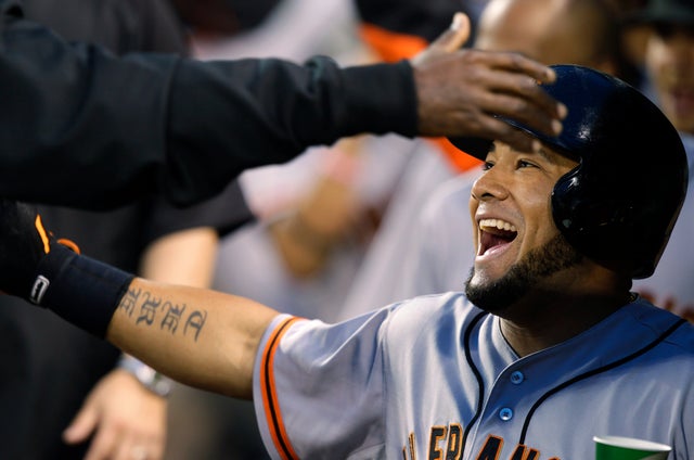 Melky Cabrera is greeted in the dugout after he hit a two-run home run 