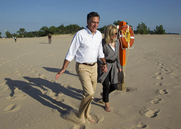 Mitt Romney, left, takes a walk with his wife Ann 