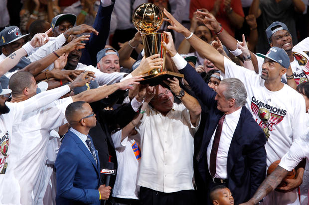 Team owner Micky Arison of the Miami Heat holds up the Larry O'Brien Championship trophy  