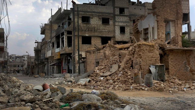 Damage and destruction litter a street in the battered city of Qusayr, Syria, June 20, 2012. 