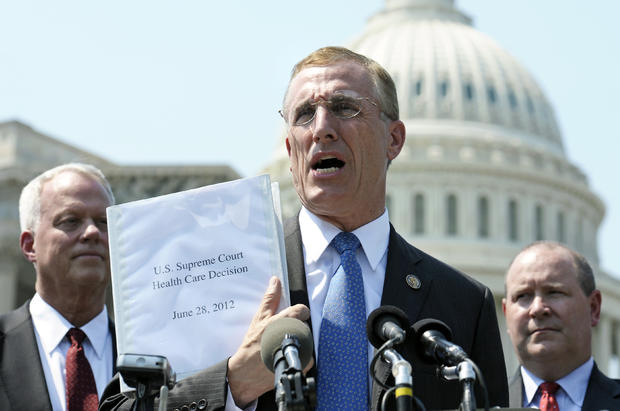 Tim Murphy holds up a copy of the Supreme Court's health care ruling  