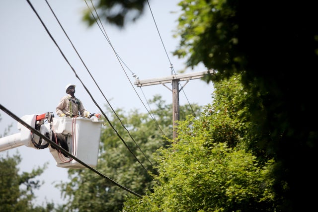 AEP crew member works on a power line on Colonial Avenue near Virginia Western Community 