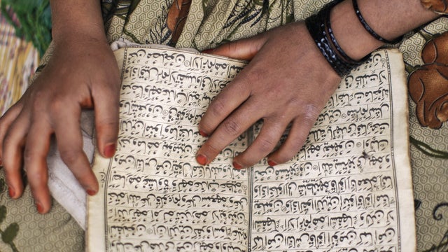 A Pakistani girl reads verses from the Quran while attending her daily madrassa, or Islamic school, set up in a local mosque on the outskirts of Islamabad, Pakistan, Wednesday, April 11, 2012.  