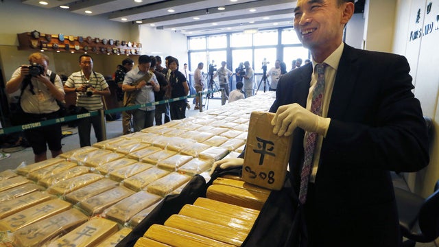 Head of Customs Drug Investigation Bureau John Lee displays the cubes of cocaine at the Hong Kong Customs and Excise Department in Hong Kong Friday, July 6, 2012.  