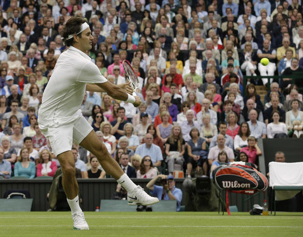Roger Federer of Switzerland plays a shot to Novak Djokovic 