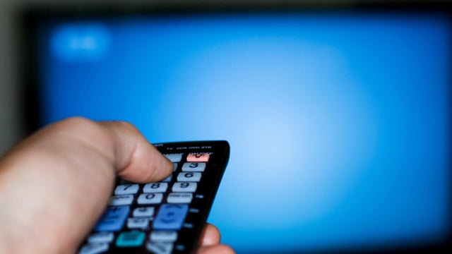 Picture of a Man using a TV Remote Control 
