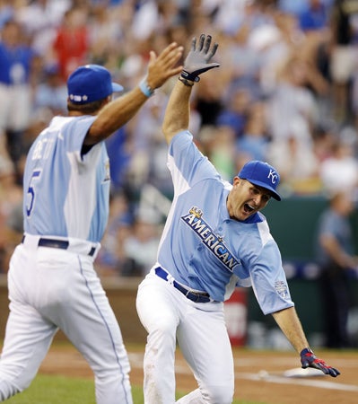 Mike Sweeney and George Brett celebrate after Sweeney hit a home run 