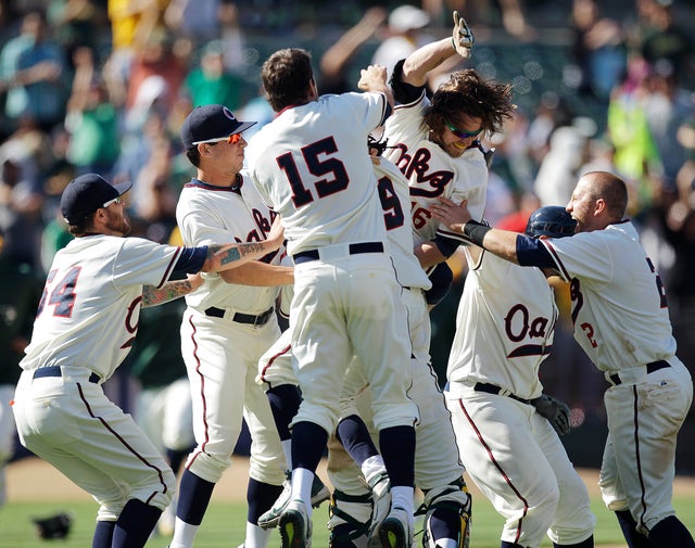 Josh Reddick is mobbed by teammates 