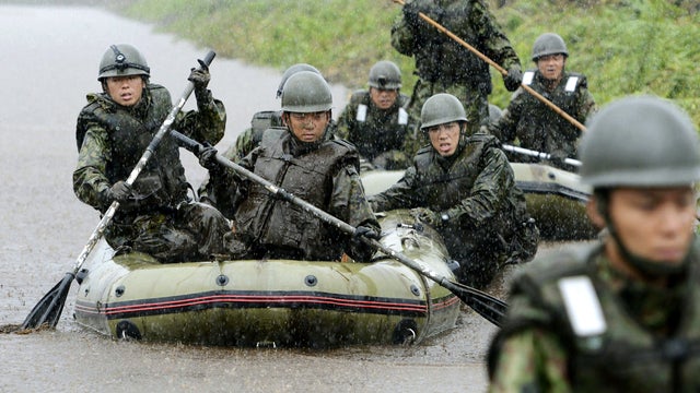 Japanese Ground Self-Defense Force personnel on rubber boats search for missing people in Aso, Japan, July 14, 2012. 
