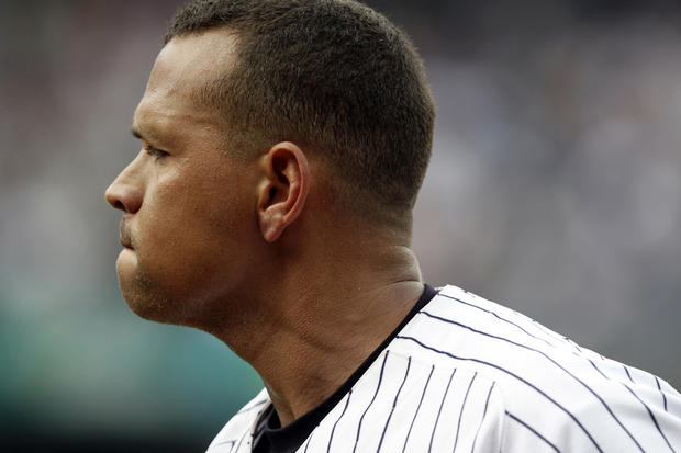 Alex Rodriguez reacts after popping out with the bases loaded  