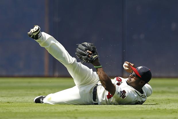 Michael Bourn throws after making a diving catch  
