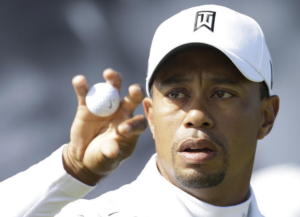 Tiger Woods holds a ball during a practice round  