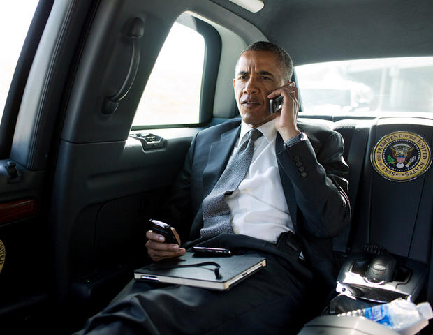 President Barack Obama talks on the phone with Aurora Mayor Steve Hogan during the motorcade ride to Palm Beach International Airport in Palm Beach, Fla., July 20, 2012. The President called Mayor Hogan to offer his condolences and support to the Aurora c 