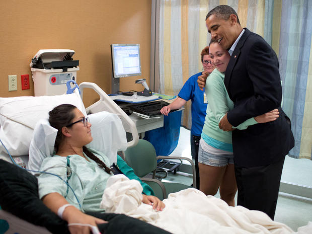 President Obama hugs Stephanie Davies, who helped keep her friend, Allie Young, alive 