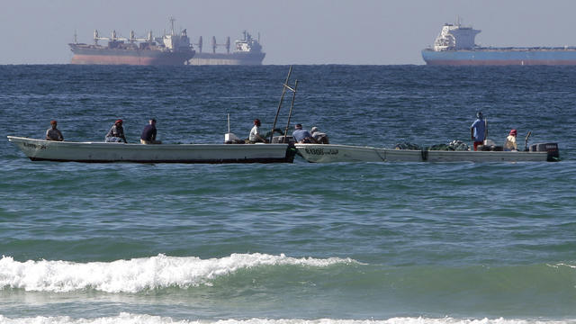 In this Thursday, Jan. 19, 2012 file photo, fishing boats are seen in front of oil tankers on the Persian Gulf waters, south of the Strait of Hormuz, off the shores of Ras Al Khaimah in the United Arab Emirates.  