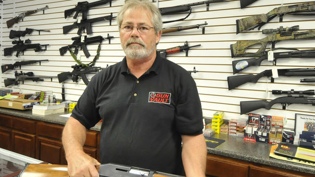 Randy Hodges holds a firearm at the Gun Vault in High Point N.C. 