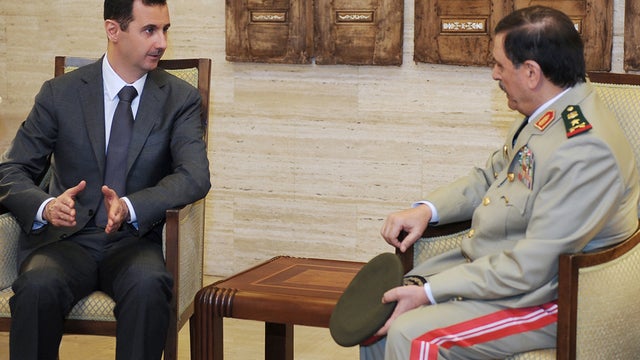Syrian President Bashar Assad, left, meets Fahd Jassem al-Freij, Syria's new Defense Minister 