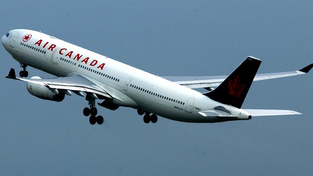 An Air Canada passenger plane is shown in flight at Heathrow Airport July 31, 2002, in London. 
