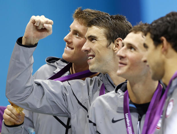 United States' Conor Dwyer, left, Michael Phelps, center, Ryan Lochte, second right, and Ricky Berens, right, pose with their gold medals 