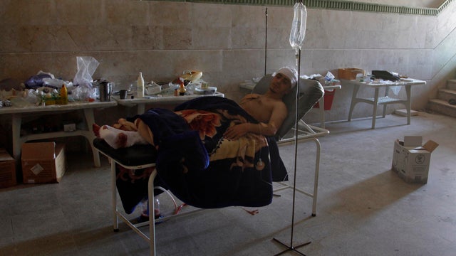 Survivor of massacre rests in field hospital 