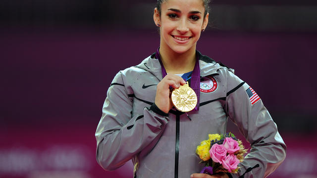 Gold medalist Alexandra Raisman, of the U.S., poses on podium during medal ceremony for artistic gymnastics women's floor exercise final 