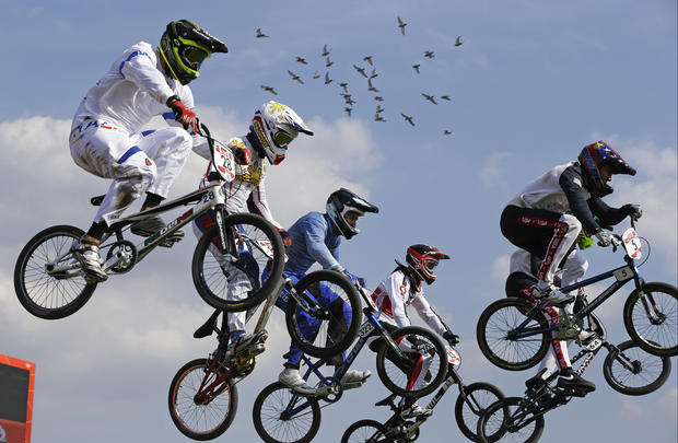 Cyclists compete in a BMX cycling men's quarterfinal run 