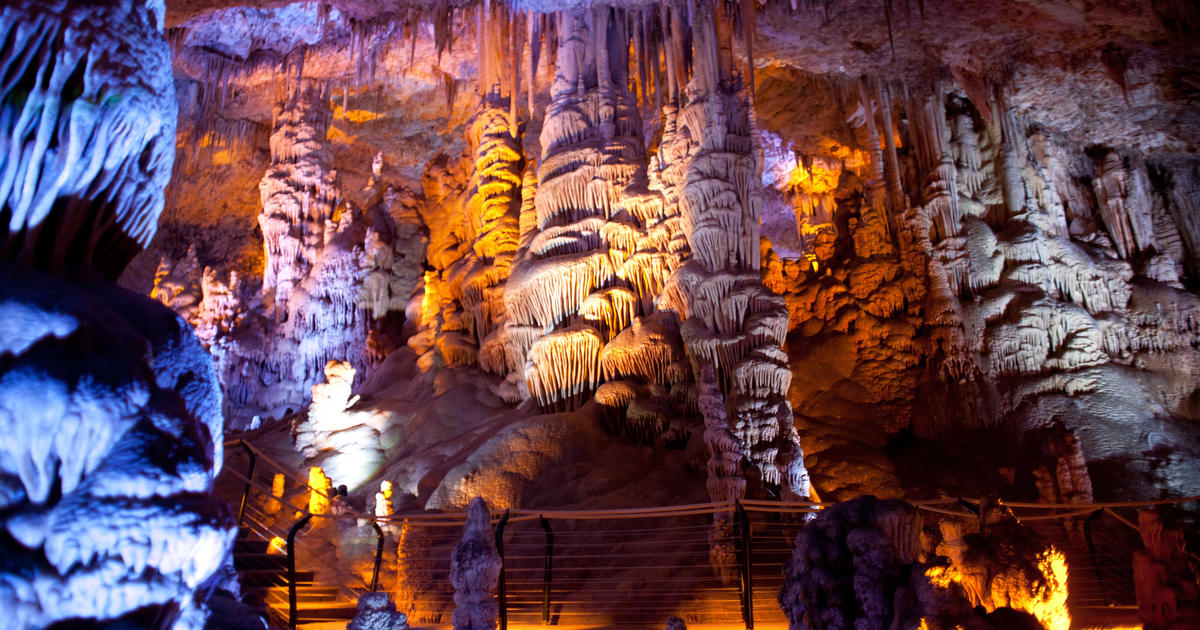 Stalactite-filled cave illuminated