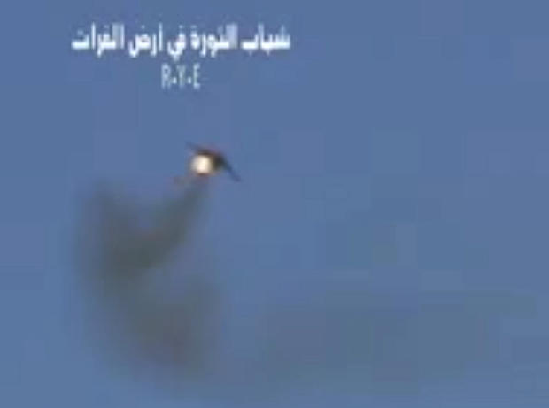 Syrian rebels claim this image, taken from a video, shows shows a government Soviet-made MiG warplane catching fire apparently after it was hit by ground fire. Syrian governments said the plane malfunctioned. 